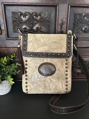 Tooled Cream Crossbody Bag with Dark Brown Trim and Tassel Accent